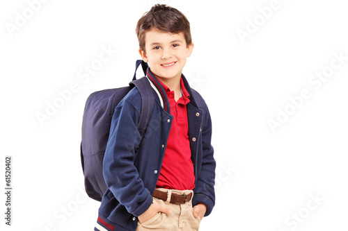 School boy with backpack standing and looking at camera