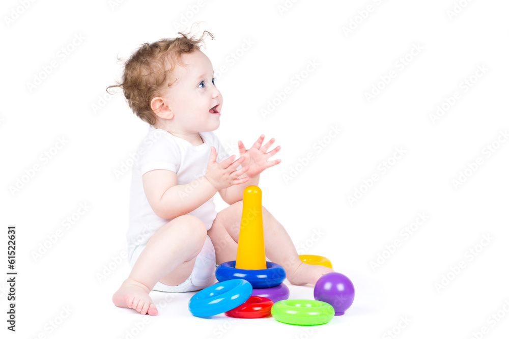 Funny curly baby playing with a plastic pyramid Funny curly baby playing with a plastic pyramid