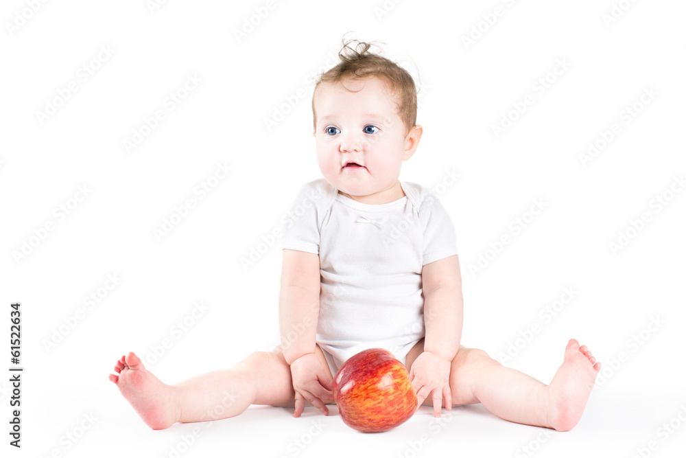 Adorable litlte baby playing with a big red apple Adorable litlte baby playing with a big red apple
