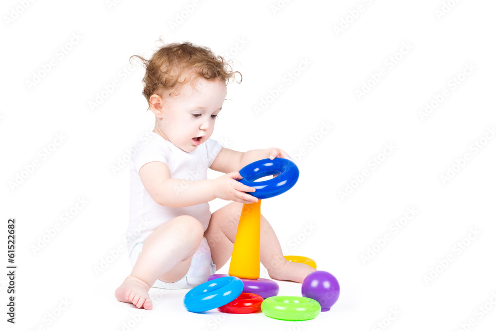 Funny baby playing with a colorful pyramid Funny baby playing with a colorful pyramid