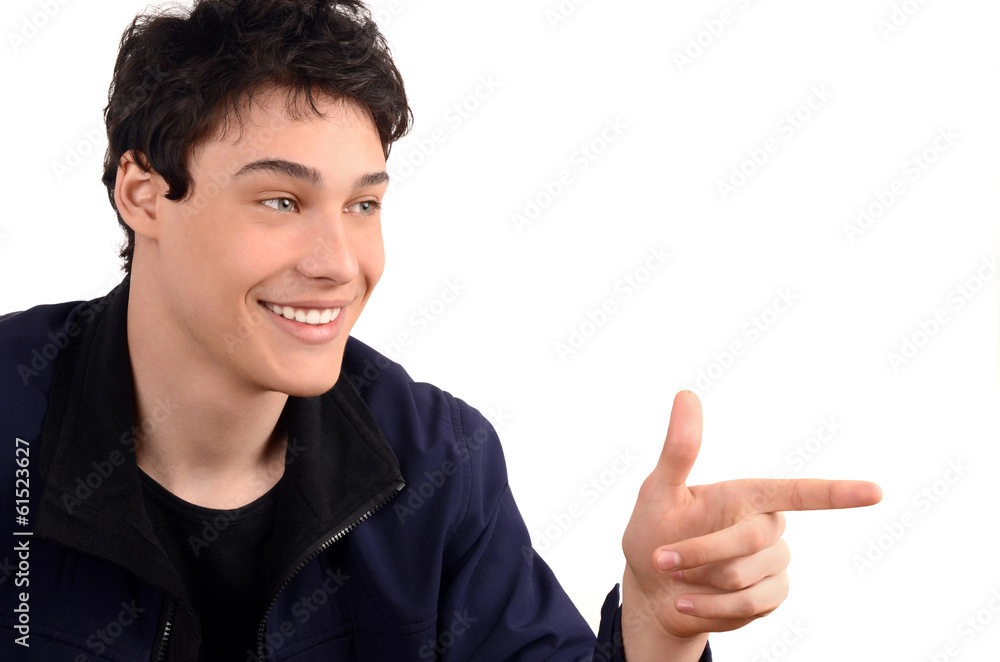 Young man smiling pointing to the side. Isolated on white. Young man smiling pointing to the side. Isolated on white.