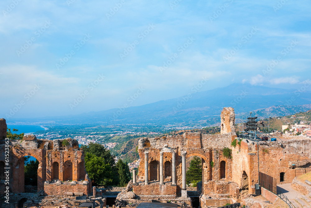 Ancient greek amphitheatre in Taormina city and mountain Etna