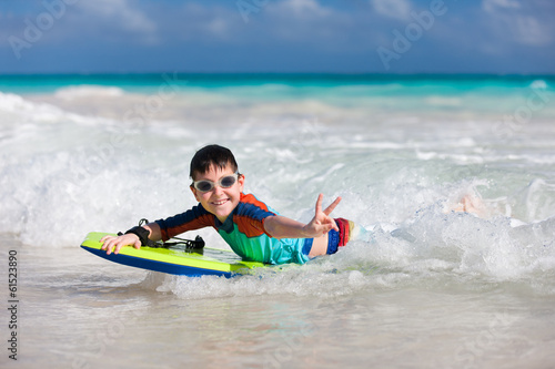 Boy swimming on boogie board
