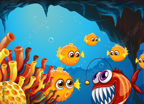 A group of puffer fishes and a scary piranha inside the cave
