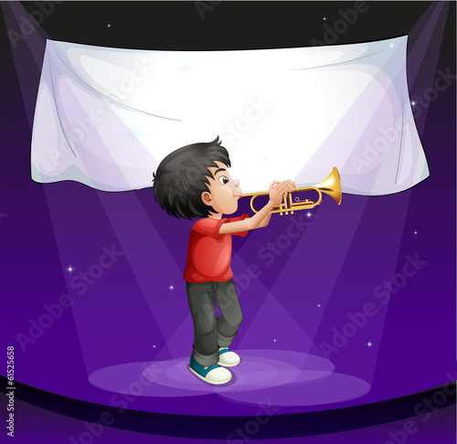 A boy performing at the stage with an empty banner