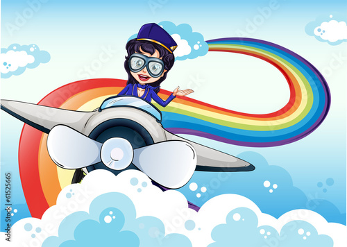 A female pilot driving the plane and a rainbow in the sky