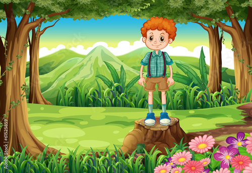 A boy at the forest standing above the stump