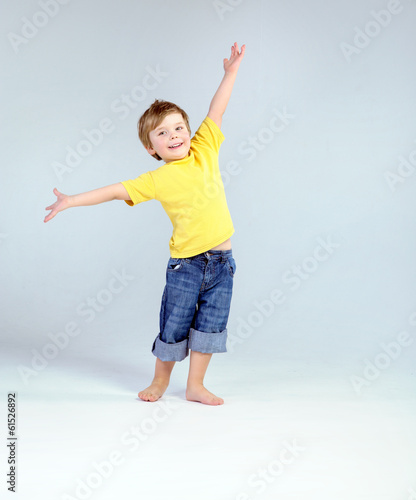 Obraz na plátně Joyful little boy playing a plane