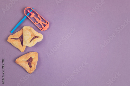 Hamantaschen cookies with grogger on purple background photo