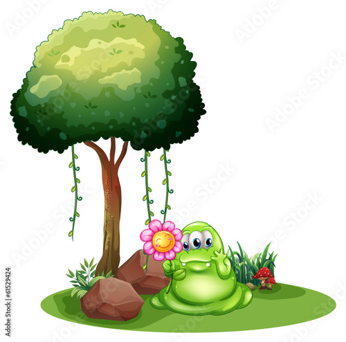 A monster holding a flower standing near the tree