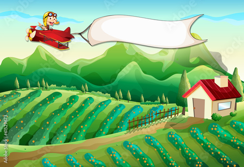 A pilot with an empty banner flying above the farm