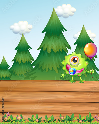 A one-eyed monster above the empty wooden signboard