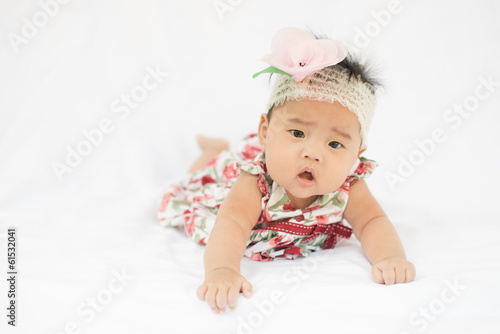 Cute baby confusing girl with rose headband