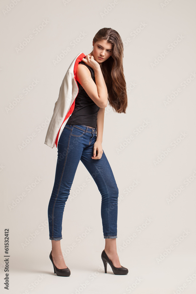 The beautiful young girl poses in studio. Clothes advertizing. The beautiful young girl poses in studio. Clothes advertizing.