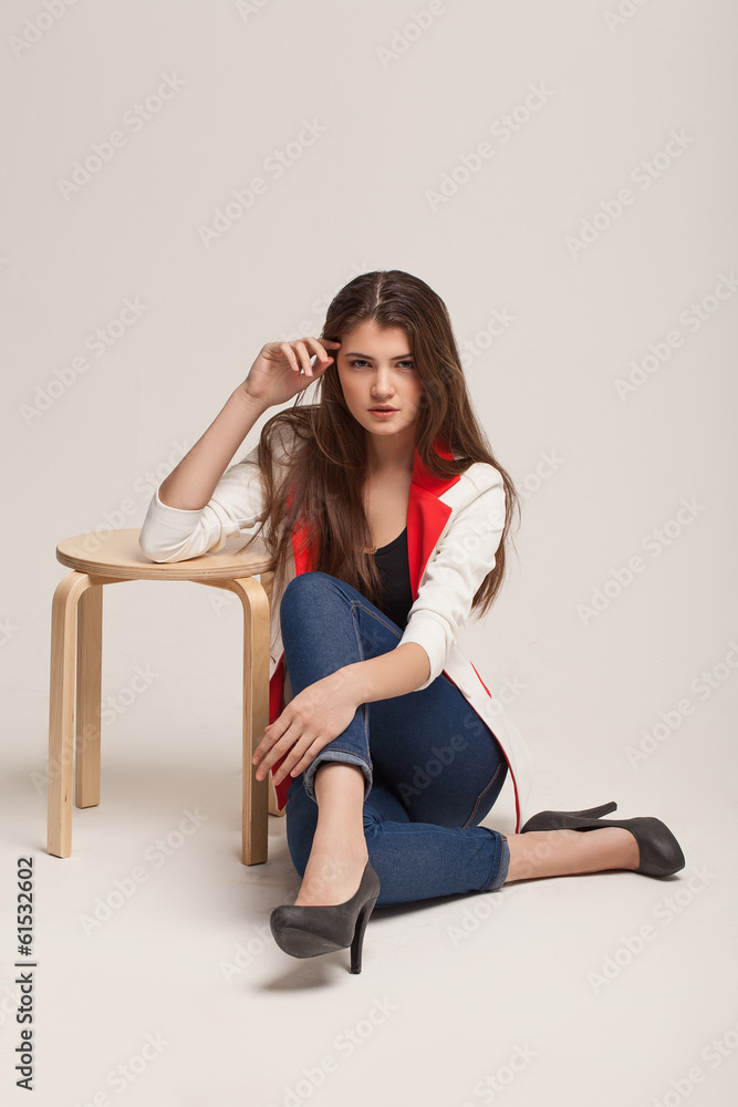 The beautiful young girl poses in studio. Clothes advertizing. C The beautiful young girl poses in studio. Clothes advertizing. C