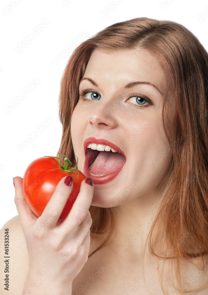 Happy beautiful young woman eating tomato Happy beautiful young woman eating tomato