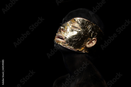 Fiction. Imagination. Futuristic Creature in Mystic Mask. Gilt