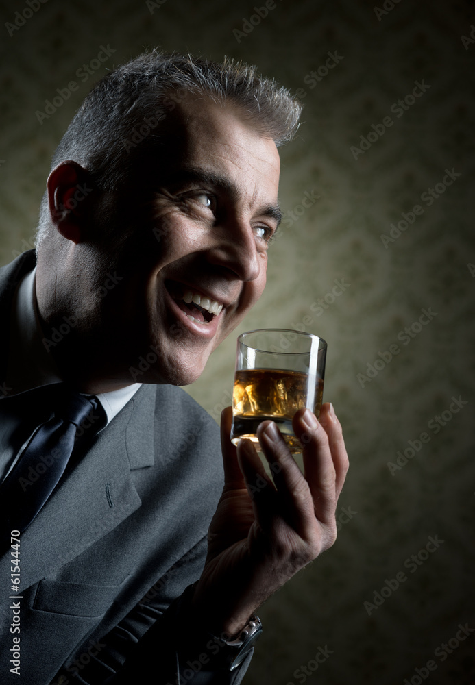 Vintage businessman holding a glass of whisky