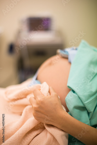 pregnant female feeling the pain of contraction labor in hospita