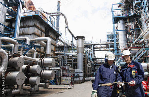 main refinery station with two fuel and gas workers