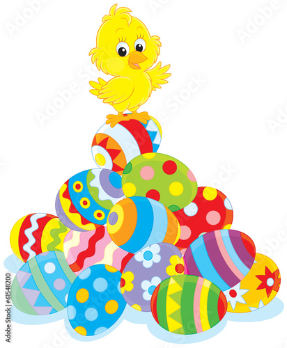 Easter Chick on top of a pile of painted eggs