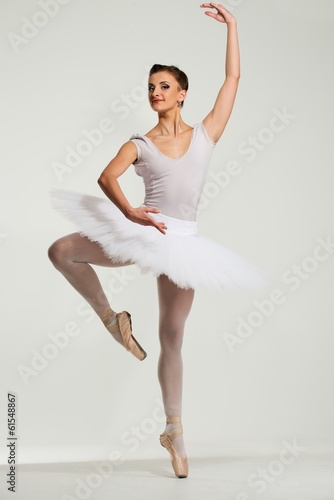 Young ballerina dancer in tutu showing her techniques
