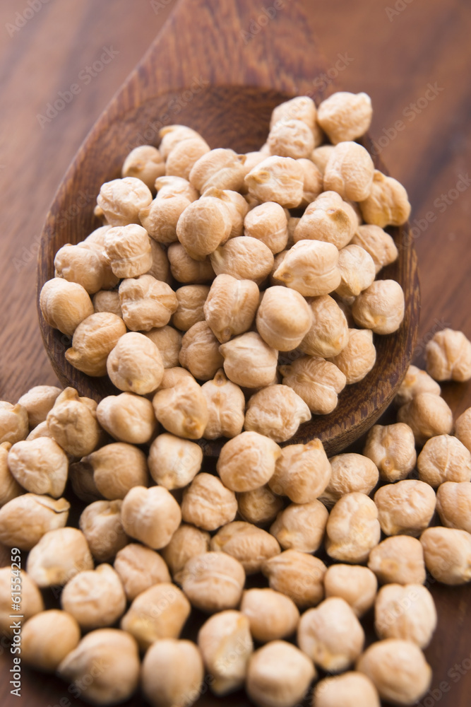 dried white chickpeas ceci on the wooden spoon dried white chickpeas ceci on the wooden spoon