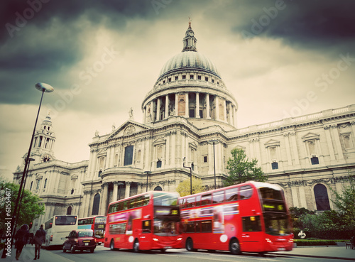 St Paul's Cathedral in London, the UK. Red buses, vintage style.