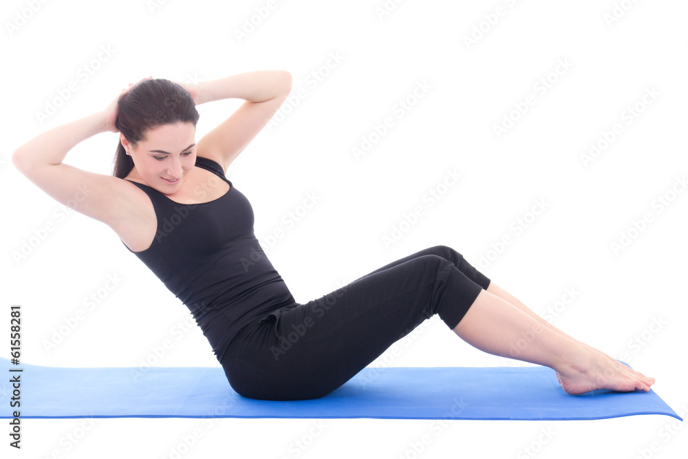 young woman doing fitness exercise on blue fitness mat isolated young woman doing fitness exercise on blue fitness mat isolated