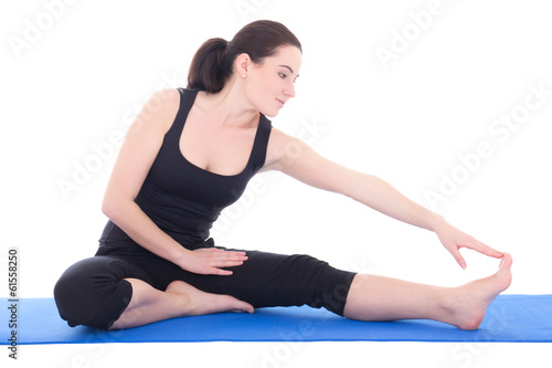 beautiful sporty woman stretching leg on the floor isolated on w
