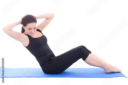 young woman doing fitness exercise on blue fitness mat isolated