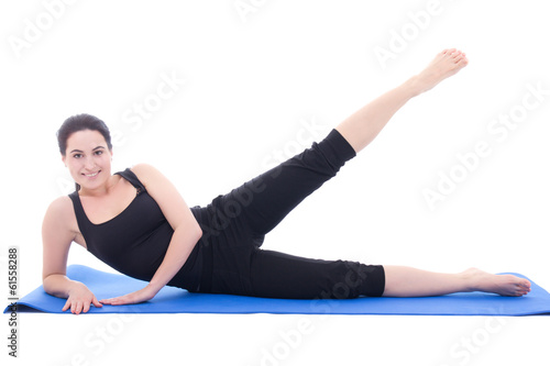 young attractive woman doing fitness exercise on blue fitness ma