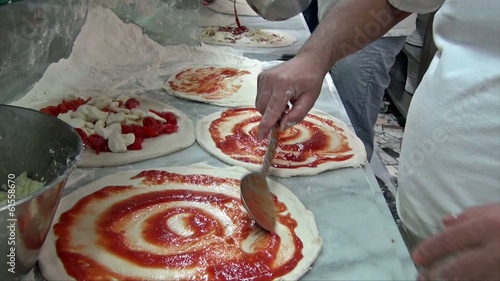 Pizza maker preparing pizza