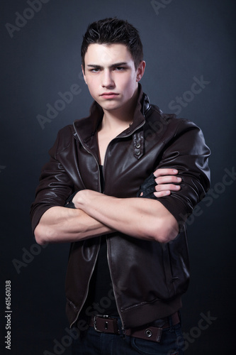 Healthy muscular young man on black