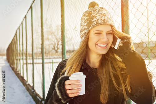 Happy young woman talking on the phone laughing photo