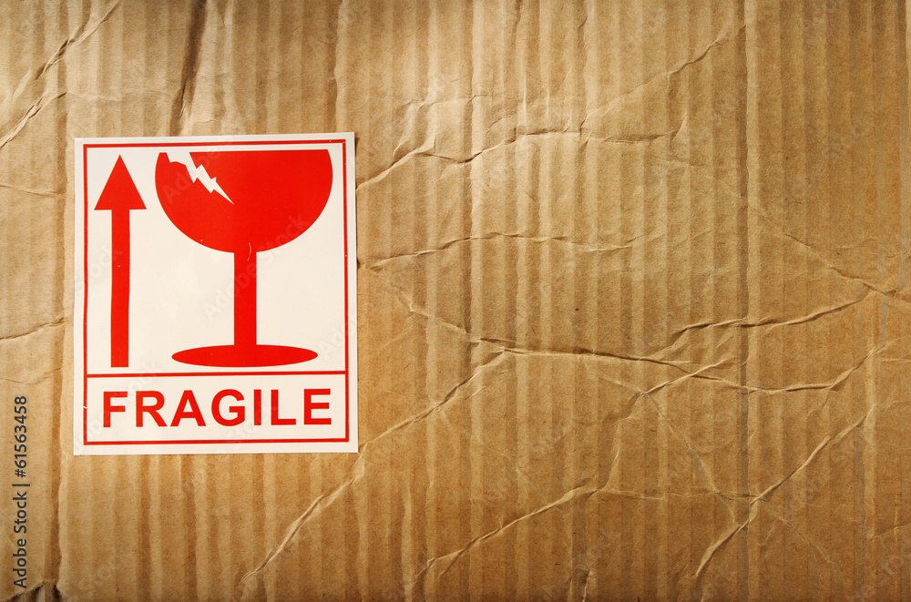 Fragile label on textured cardboard background Stock Photo | Adobe Stock
