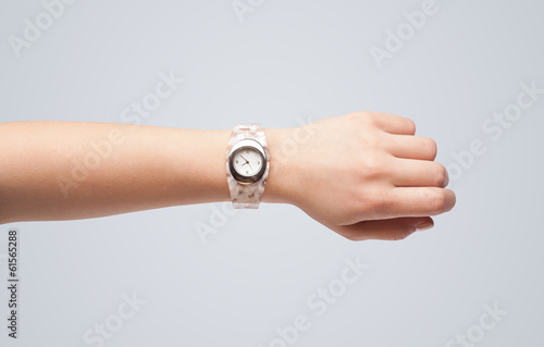 Hand with watch showing precise time
