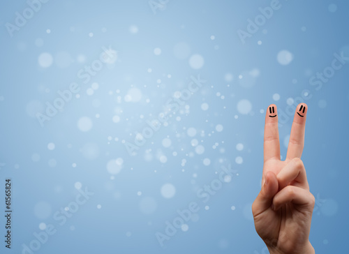 Happy finger smileys with empty blue bokeh background