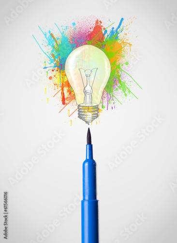 Felt pen close-up with colored paint splashes and lightbulb photo