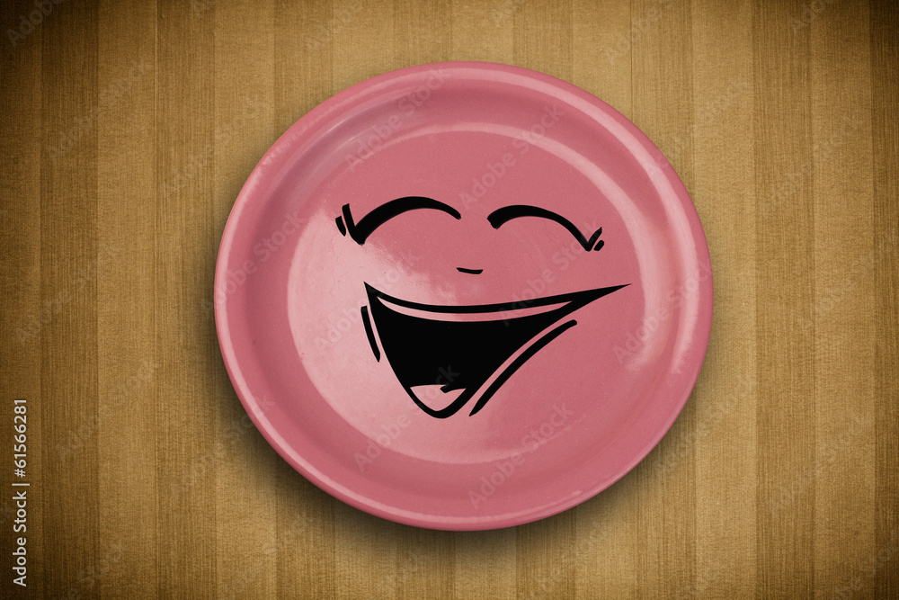 Obraz premium Happy smiley cartoon face on colorful dish plate