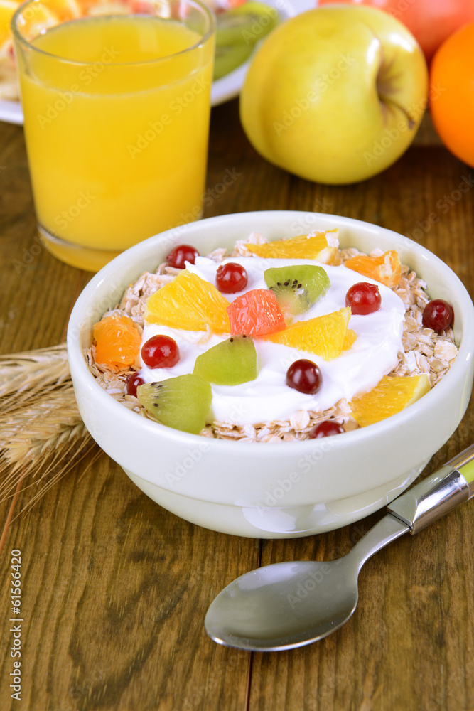Delicious oatmeal with fruit in bowl on table close-up Delicious oatmeal with fruit in bowl on table close-up