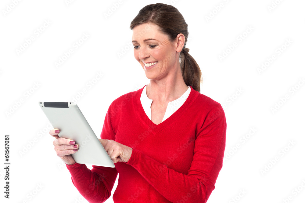 Smiling woman operating touch pad device Smiling woman operating touch pad device