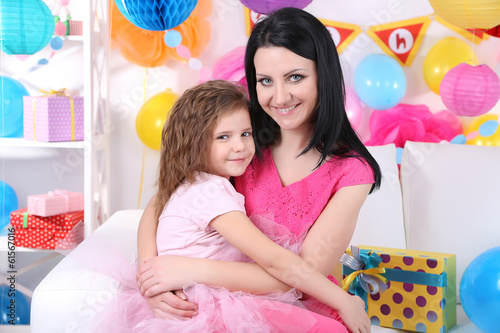 Pretty little girl with mom celebrate her birthday
