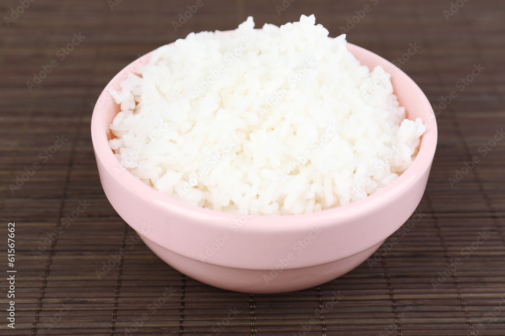 Cooked rice in bowl on bamboo background Cooked rice in bowl on bamboo background
