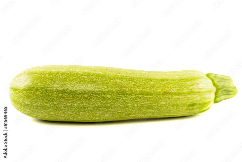 Single Courgette or zucchini from low perspective isolated on wh Single Courgette or zucchini from low perspective isolated on wh