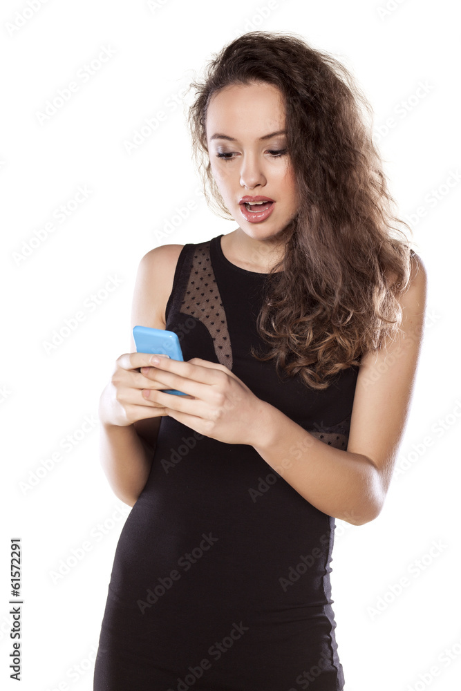 excited young girl writes text message on her phone excited young girl writes text message on her phone