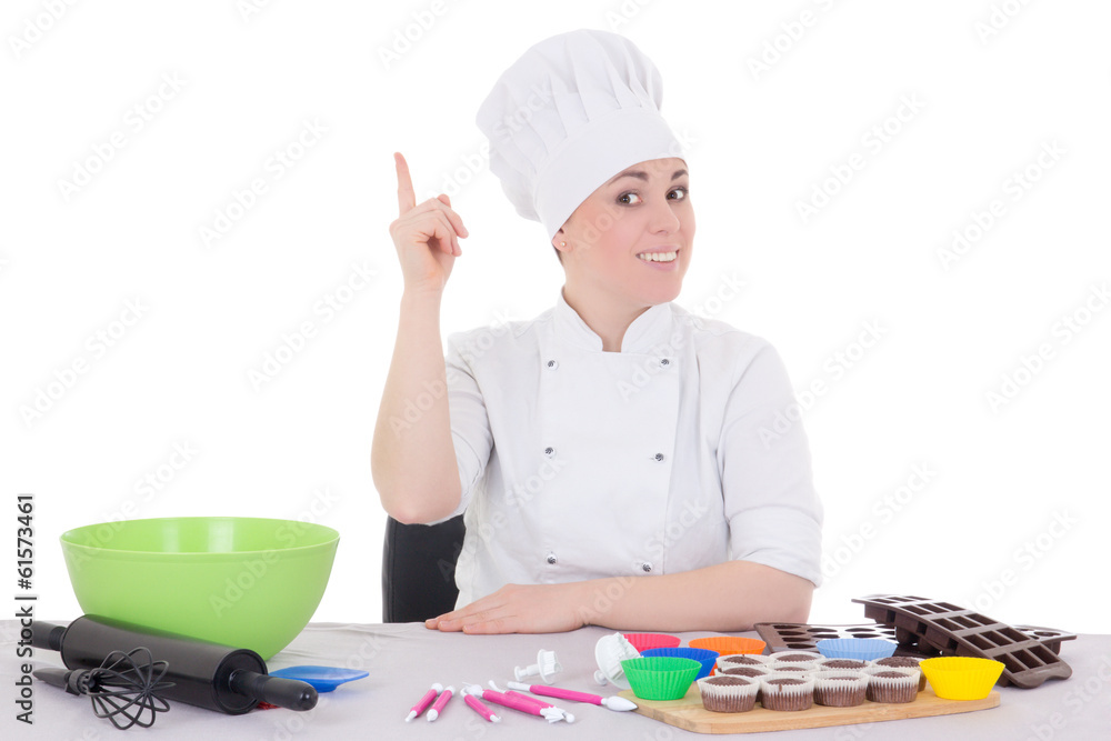 attractive female confectioner in cook uniform sitting at the ki attractive female confectioner in cook uniform sitting at the ki