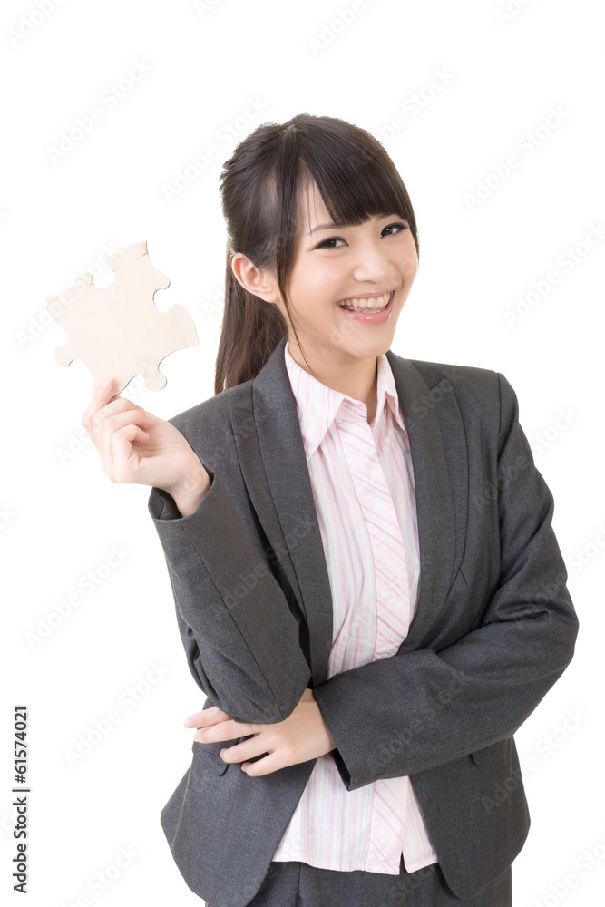 Asian business woman holding a piece of puzzle Asian business woman holding a piece of puzzle