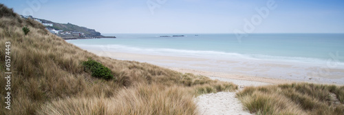 Panorama landscape across grassy sand dunes on beach