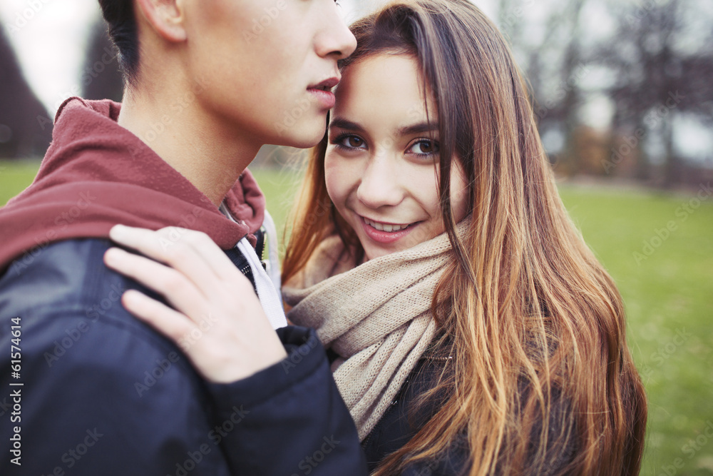 Beautiful teenage girl with her boyfriend in park Beautiful teenage girl with her boyfriend in park